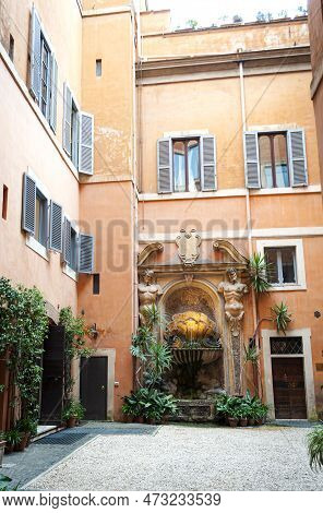Beautiful Patio With A Fountain,statues And Greenery In A Building In Central Rome, Italy.