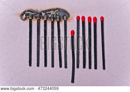 Row Of Burned Black Wood Matches Interrupted By One Standing Out. Concept Of Power Of Difference.