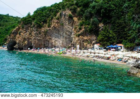 Sun Loungers And Umbrellas On The Sandy Morgen Beach Located Near The City Of Budva. Montenegro.