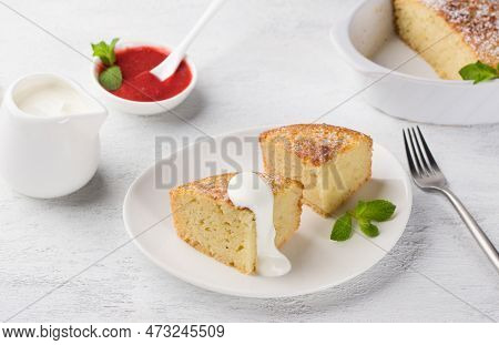 Freshly Prepared Mannik, Semolina Pie Sprinkled With Powdered Sugar With Sour Cream And Berry Sauce 