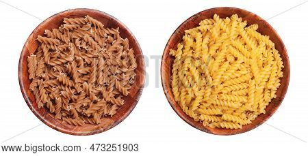 Yellow Fusilli Pasta In Wooden Bowl. Whole Wheat Fusilli Pasta. Compare Two Types Of Pasta - Brown A