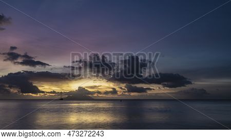 Fantastically Beautiful Tropical Sunset. Purple Clouds In The Sky, Highlighted In Pink And Gold. Ref