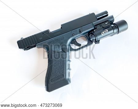 Bangkok Thailand - 21 March 2023: Air Soft Gun Glock 18C Pistol Gun With Flashlight Sight On The Whi