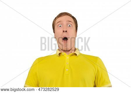Surprised Young Guy With Funny Face In Yellow T-shirt, White Isolated Background. Shocked Amazed Fac
