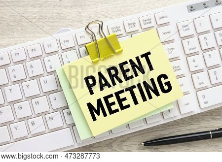 Parent Meeting Yellow Sticker With A Clip On A White Keyboard. Text In Black
