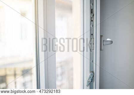 White Plastic Window Frame With Fittings Close-up. Upvc Windows And Doors Accessories And Hardware.
