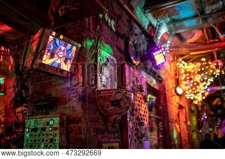 Interior Of Szimpla Kert, Famous Ruin Pub In Budapest At Night. Old Computer Screens On The Walls. N