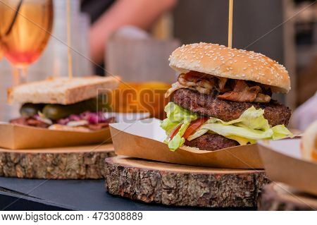 Fresh Large Burger With Meat Cutlet And Sandwich On Wooden Board On Counter For Sale At Summer Local