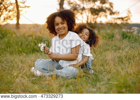 Two African American Sister Embracing In A Park