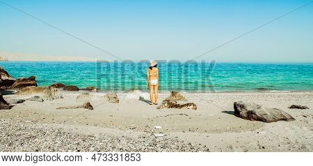 Panorama Tourist Woman In Bikini Stand On White Sand Beach Alone On Vacation In Persian Gulf Mirella