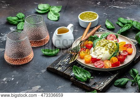 Burrata Cheese With Tomatoes And Green Pesto. Vegetarian Italian Food. Food Recipe Background. Close