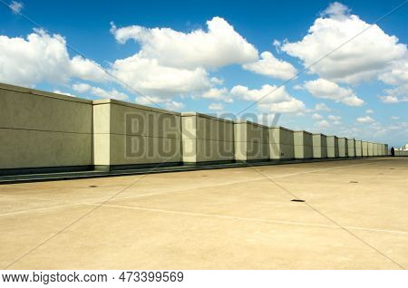 Composition Of Blue Sky, White Clouds, Smooth Walls, And Stark Shadows