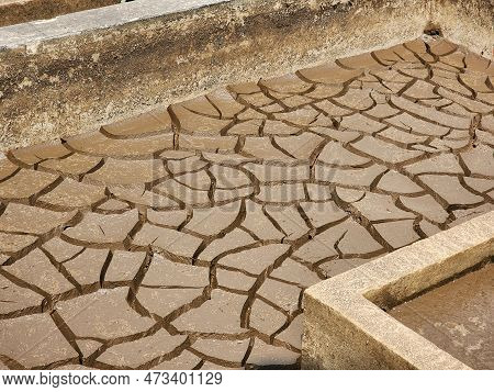 Dry And Cracked Soil Or Sediment Of The Treatment Pond