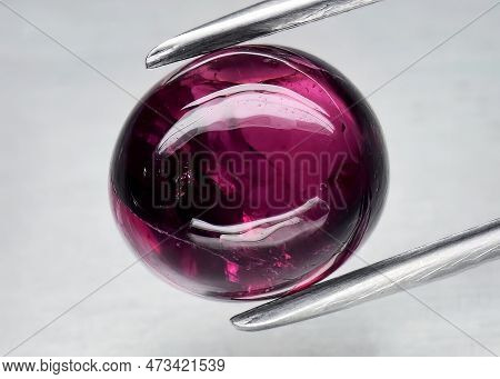 Natural Gem Red Rhodolite Garnet On Gray Background