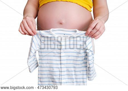 Baby Shirt In The Hands Of A Pregnant Woman, Isolated On A White Background