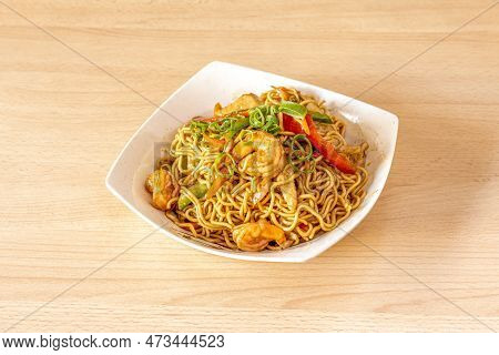 Yakisoba Noodles With Shrimp And Peeled Prawns, Chopped Chives And Sauteed Peppers And Vegetables In