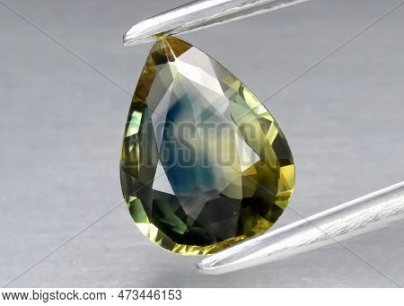 Natural Gemstone Green Sapphire On Gray Background