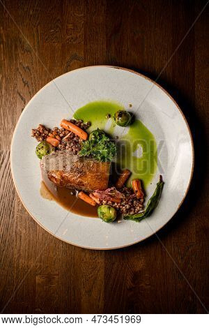 Top View On Plate With Piece Of Baked Pork Meat With Buckwheat And Vegetables