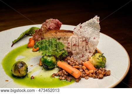 View On Dish Of Piece Of Baked Meat With Buckwheat And Vegetables On Plate