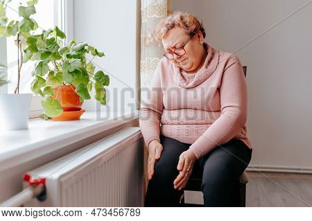 Painful Struggle An Overweight Woman Suffers With Leg Pain At Home, A Senior Woman Holding Onto Her 