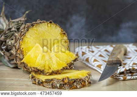 Wonderful Ripe Pineapple Cut In Half, Slices And Chunks Ready To Peck. Ripe Fruit Chopped By A Woode