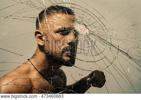 Determination To Succeed. Muscular Man Having Inner Determination And Commitment To Break Glass Wall