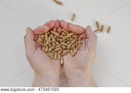 Guarana Capsules In Male Hands On A White Background.natural Energy Biostimulator.natural Tonic.alte