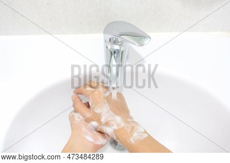 Hand Of Beauty Woman  Wash Your Hands At The Wash Basin With Foam, Cleanse The Skin And Have Water F