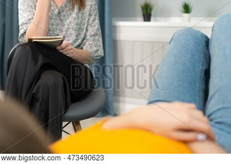 Female Psychologist Conducts A Psychotherapy Consultation With A Girl Who Is Lying On The Couch And