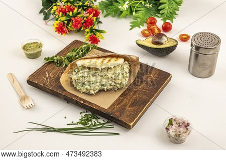 Venezuelan Popular Recipe Of Arepa Reina Pepiada With Chicken, Mayonnaise, Ripe Avocado, Onion And C