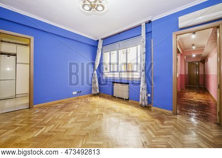 Empty Living Room With Walls Painted In Chillo Blue, French Oak Parquet Floors Laid In A Herringbone