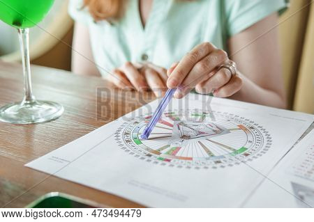 Tver, Russia - August 2, 2021. A Woman In A Cafe At A Table Is Studying The Design Of A Person. The 