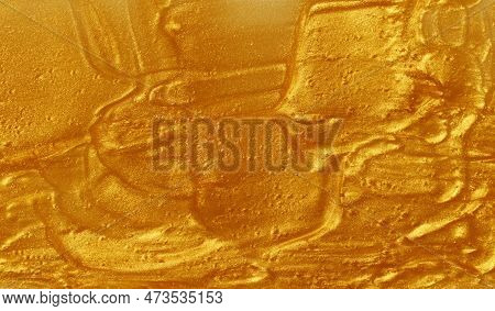 Sample Of Golden Glitter Gel With Small Particles, Texture Of Highlighter Cosmetics