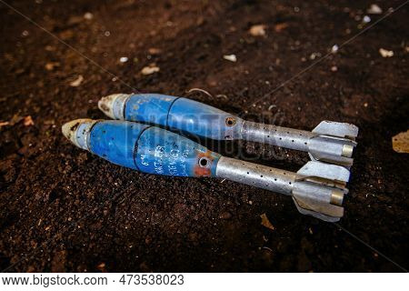 Unexploded Mortar Mines On Ground. War Actions Aftermath