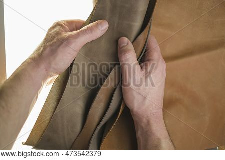 Genuine Leather Pieces Set In Male Hands On A White Background.selection Of Leather Material.genuine