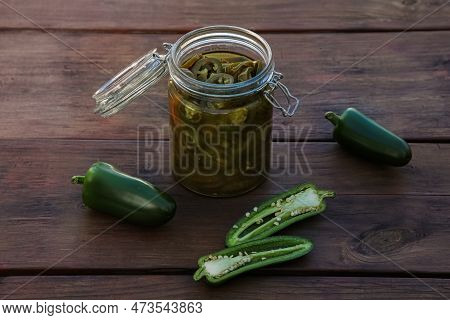 Fresh And Pickled Green Jalapeno Peppers On Wooden Table