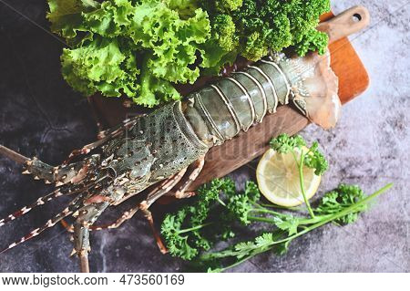 Spiny Lobster Seafood On Wooden, Fresh Lobster Or Rock Lobster With Herb And Spices Lemon Parsley On