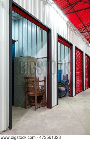 Corridor Of Self Storage Unit With Red Doors. Rental Storage Units