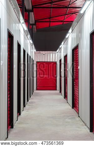 Corridor Of Self Storage Unit With Red Doors. Rental Storage Units