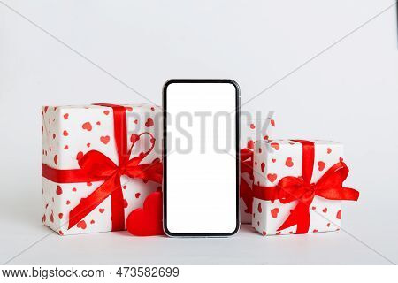 Mobile Phone With Blank Screen On Colored Background With Hearts, Calendar And Gift Box, Valentine D
