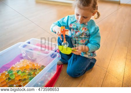 Little Girl Playing With Sensory Water Beads, Hydrogel Balls. Sensory Development And Experiences, T