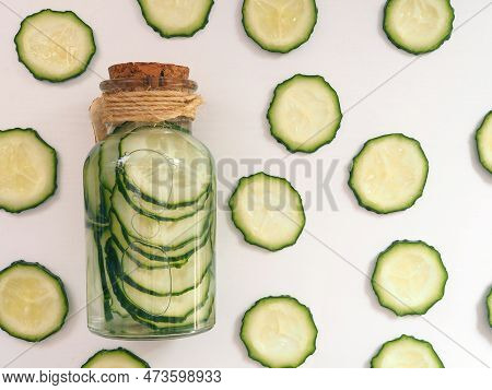 Сucumber Slices In A Bottle Filled With Water, Cucumber Water Or Skin Tonic. Flat Lay.