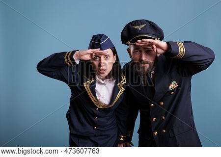 Portrait Of Airplane Capitan And Flight Attendant Couple Looking At Camera, Medium Shot. Aircrew Tea