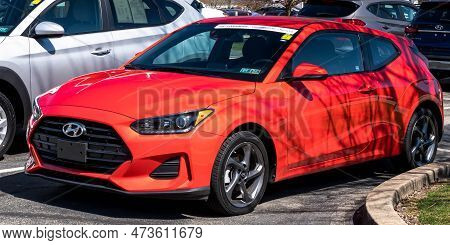 Monroeville, Pennsylvania, Usa March 26, 2023 A Used, Orange Hyundai Coupe Hatchback For Sale At A D