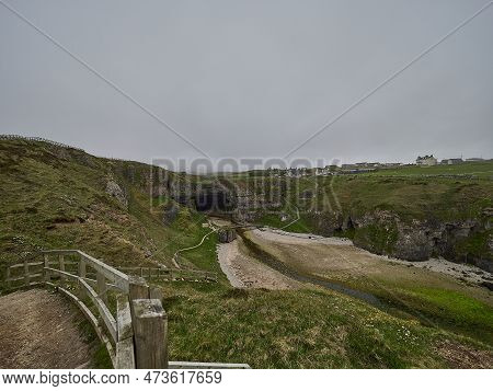 Entrance Of Smoo Cave At The Coastline Of The Atlantic Ocean In Northern Scotland.