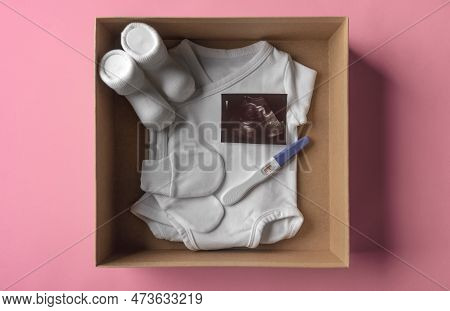 Box With Baby Stuff And Pregnancy Test. Waiting For A Baby.