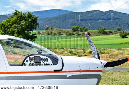 Single Engine Ultralight Airplane Waiting To Take Off At The Airfield With Blue Sky And Field Backgr