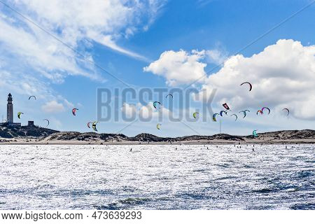 People Practicing Kitesurfing On The Beach Of Los Caños De Meca, Next To The Trafalgar Lighthouse, B