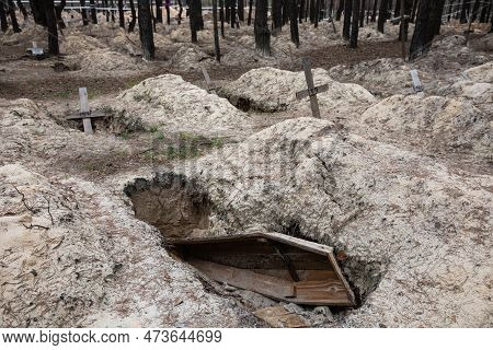 Crosses Are Seen At A Forest Grave Site After An Exhumation In The Town Of Izium, Recently Liberated