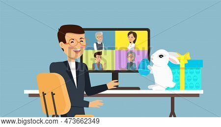 Easter In Office, Man Sitting At Table With White Bunny, Egg And Gift. Video Conference With People 
